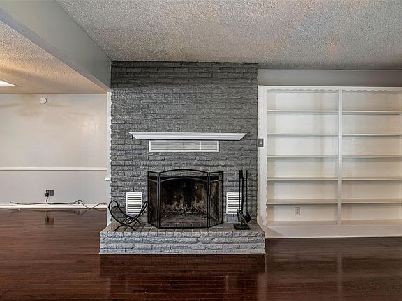 Living room fireplace with built in shelves