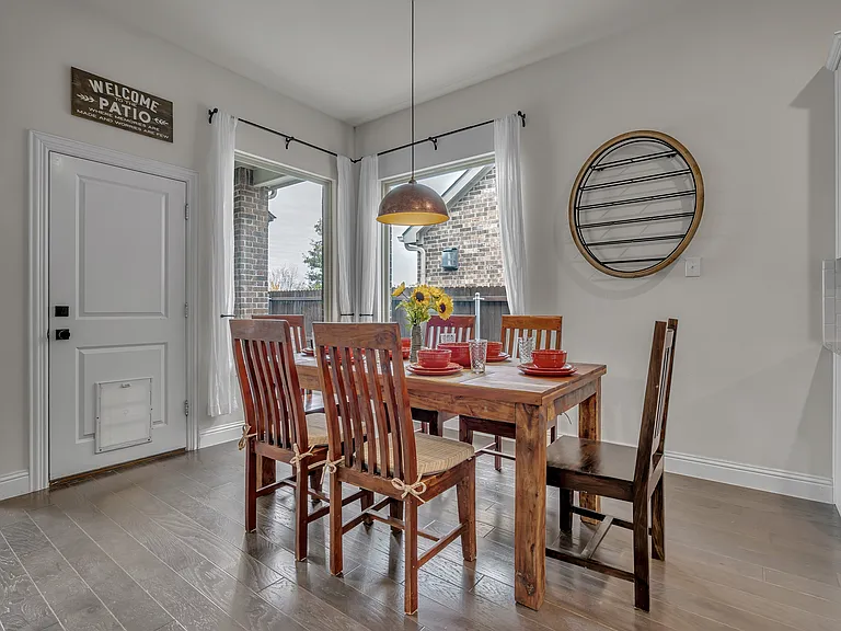 Dining area with seating for 6 plus 2 at the island. A doggie door for up to a 70 lb dog is inset into the door to the backyard.