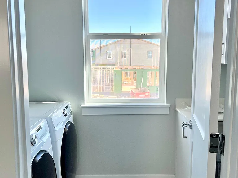 Large laundry room with sink and plenty of storage. Brand new Samsung washers with Steam function.