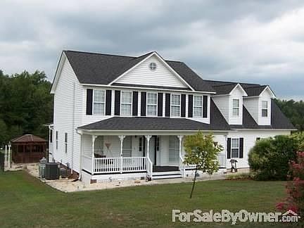 Lovely facade
						:
						Porch swing ready for you to relax. At night spotlights make the house shine!
