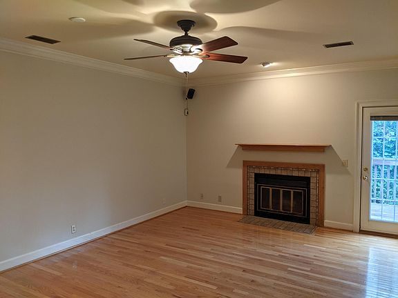 living room with wood burning fireplace and access to deck