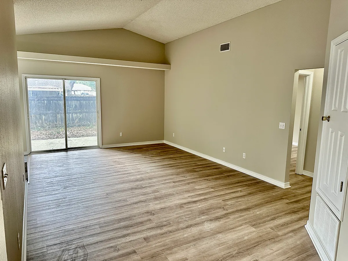 Living area, patio door to fenced backyard - 1191 Simpson St