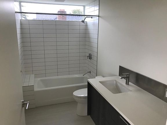 Bathroom with radiant heated floors, quartz counter & subway tiles