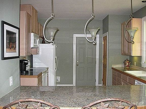 Enjoy preparing meals in your new kitchen -- lots of counter and storage space, plus a large bar for serving quick breakfasts or snacks! Refrigerator stays!