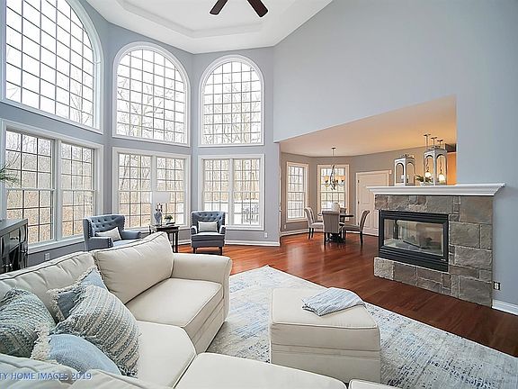 The exquisite floorplan allows for grand entertaining and cozy gatherings. The see-through gas fireplace can be enjoyed not only in the family room, but also in the breakfast room and kitchen.