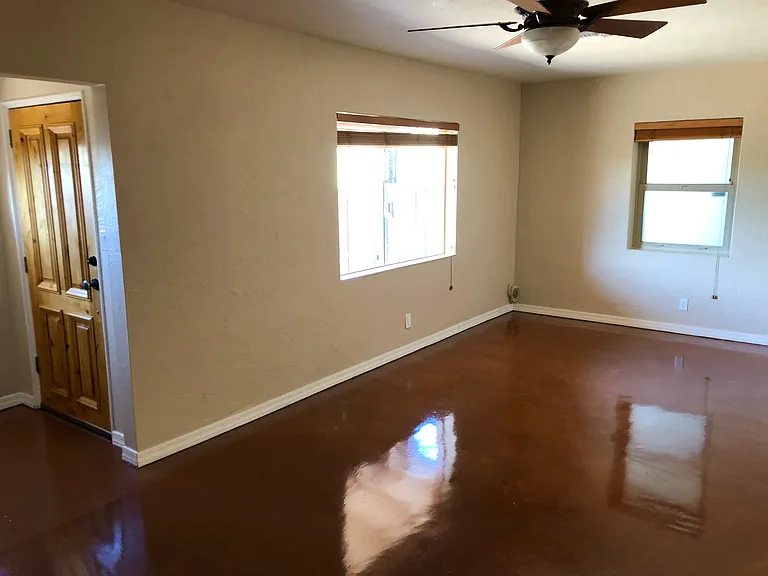 Living room with no furniture. Front door on the left of photo. Front large window has Catalina Mountain views.