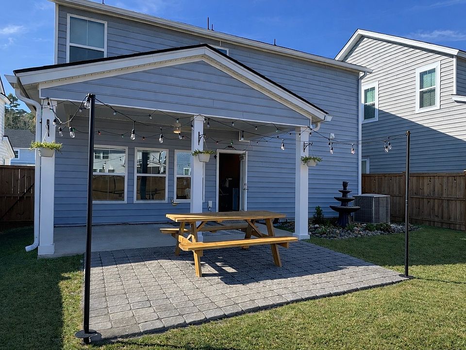 Covered back patio with custom paver extension. Ideal for hosting outdoors!