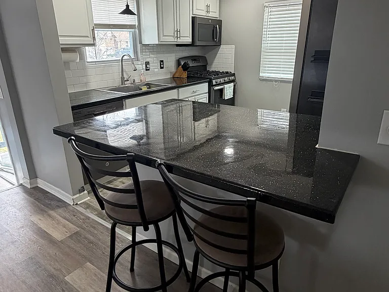 Breakfast bar in between the living room and the kitchen