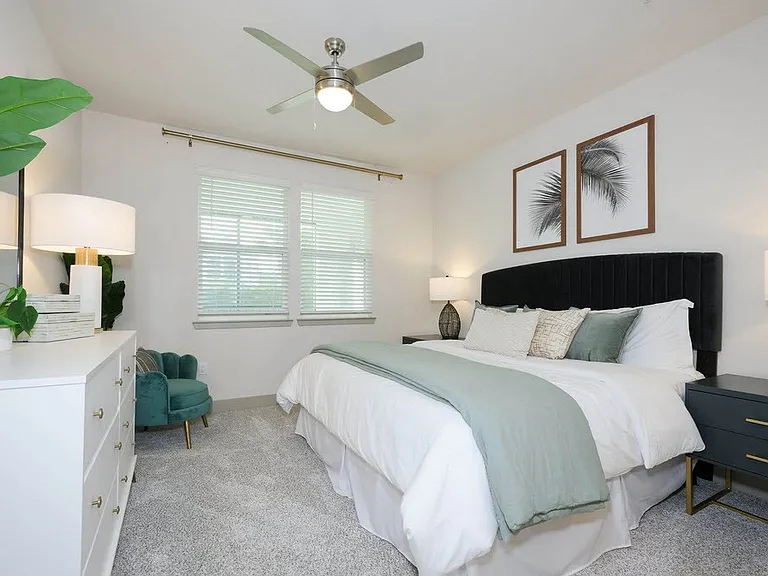 Elevate your lifestyle at The Edison Daytona Apartments with this beautifully designed bedroom featuring modern decor, ample natural light, and plush furnishings. Cozy and serene, it's the perfect retreat after a long day. Schedule your visit today!