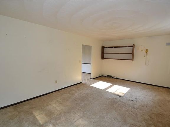 Living Room approximately 18 x 12 with natural light, neutral decor and a detailed ceiling
