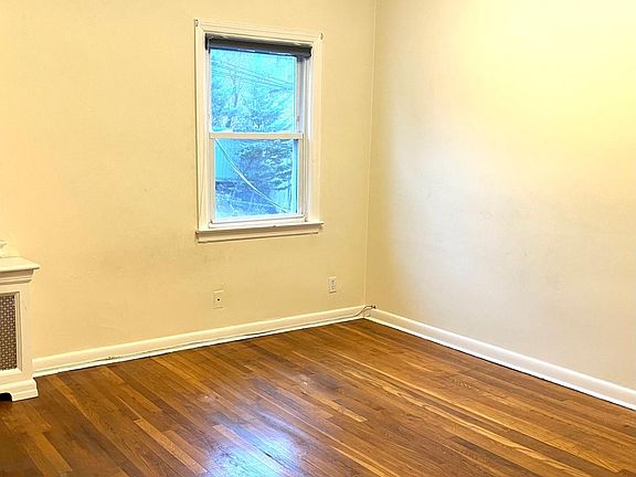 Another view of sunny bedroom with 2 windows.