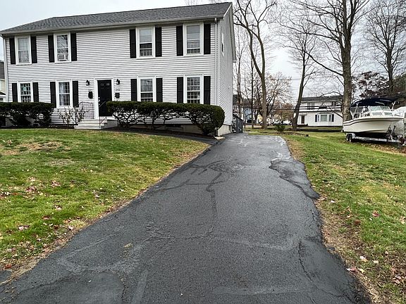 Long private driveway that can accommodate 3 cars; each unit in this Duplex has its own private driveway