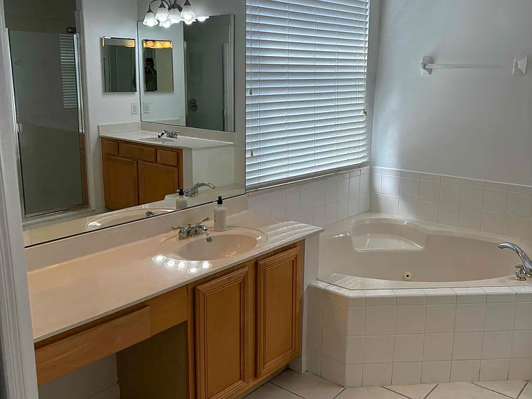 Master bath with Roman tub and his and hers vanities