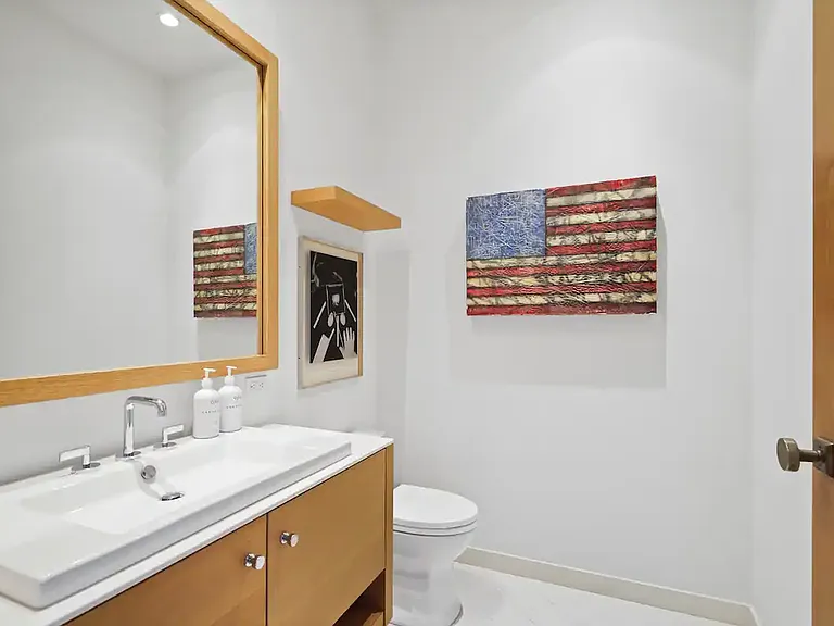 Guest bathroom features modern amenities and sleek finishes.