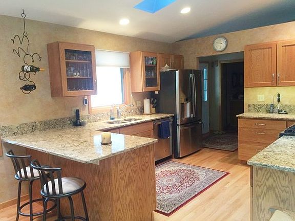 Beautiful new kitchen recently done in 2014 - vaulted ceilings and skylights enhance the room even more!  Features include quartz countertops, oak cabinets and flooring, and Stainless Steel appliances - and yes, city water too!