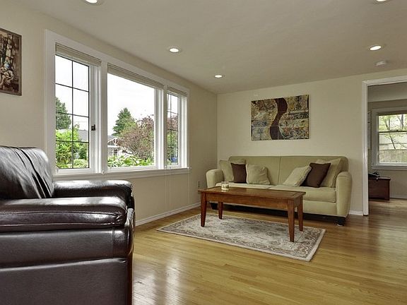The living room is light and bright and features new hardwood floors and leaded glass windows that open.