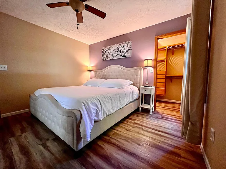 Primary bedroom on upper level with walk in closet and solid wood cabinets. King sized Tempurpedic mattress.