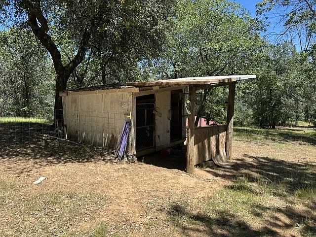 covered horse stall in a separate cross fenced area.
