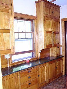 The kitchen boasts original cabinets and granite counter tops.