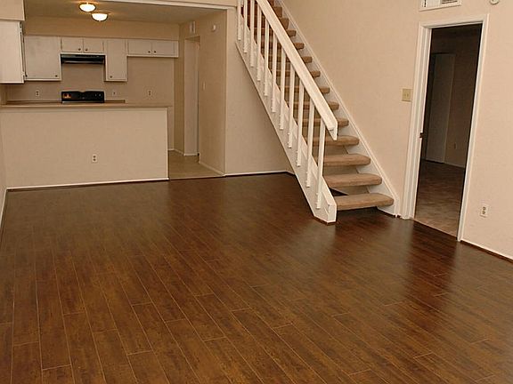 Rich Laminate Wood Flooring in Living/Dining Room