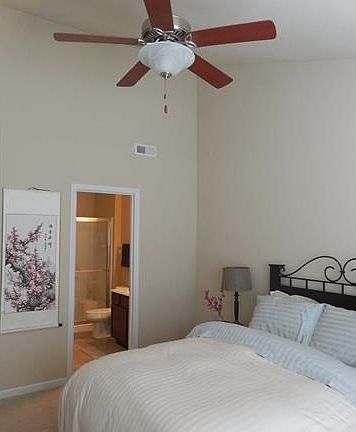 Vaulted master bedroom suite is bright and neutral.