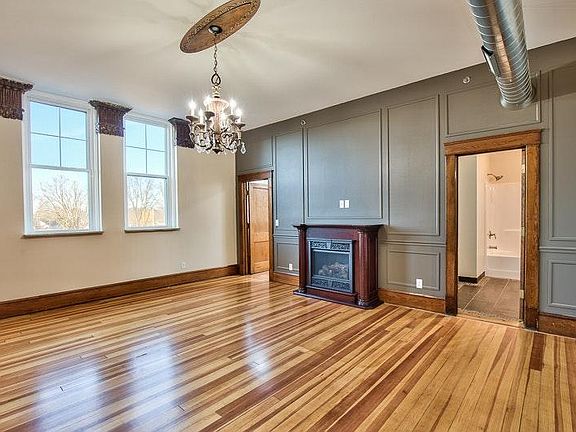 beautiful cherry fireplace and wood floors throughout