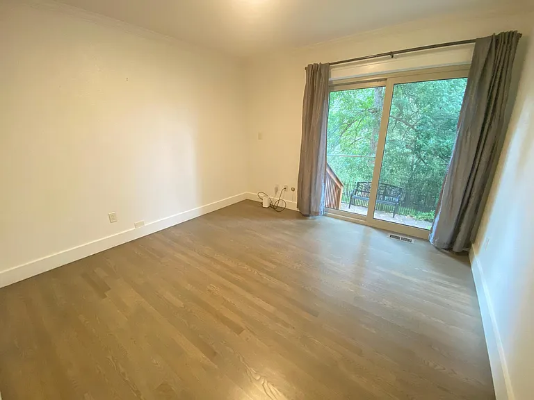 Main floor back bedroom with patio access.