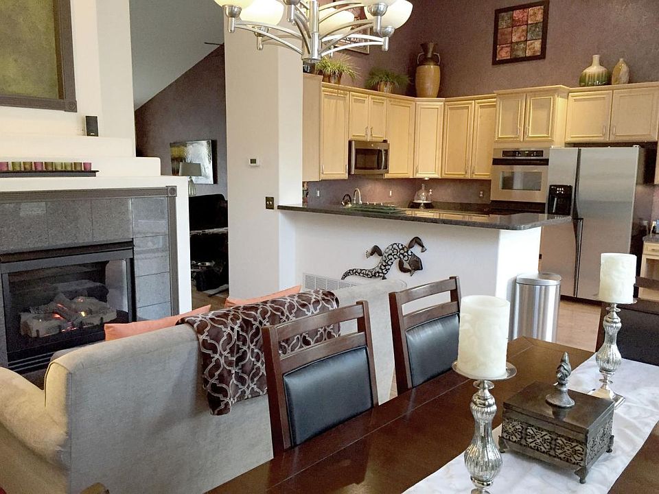 The kitchen features a dining area that seats 8, sofa & fire