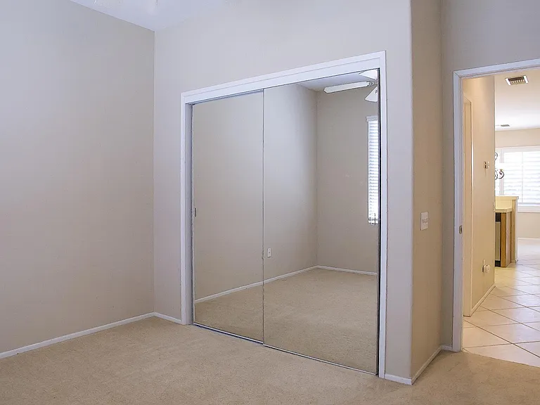 Guest bedroom with mirrored doors