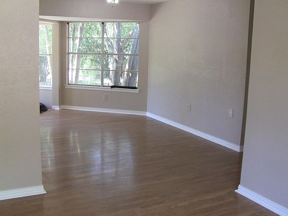 Living room has bay window with window seat