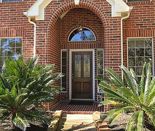 Mature landscaping, with sprinkler system, leads to your covered front door