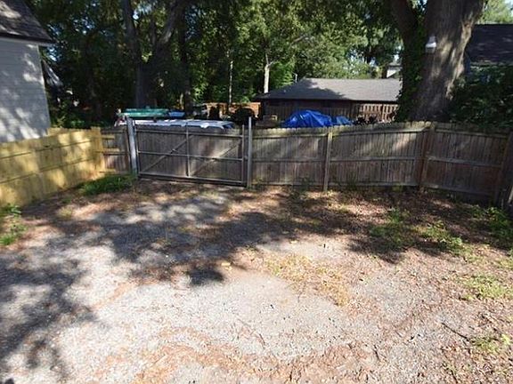 Back yard. Parking/yard with deck.