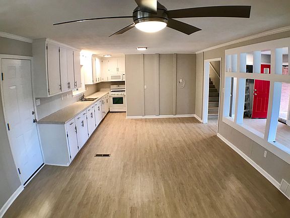 Kitchen and Open Dining-Living Area with Red Main Entry Door