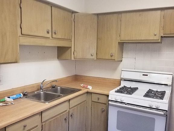 Cabinets redone. A new stove has since been put in (not pictured). There's also a new frig. Flooring is also new.