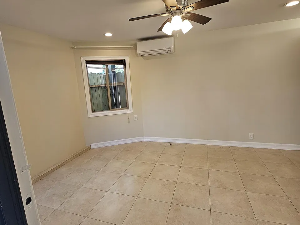 Bright unit with tile floor and recessed lights. AC and ceiling fan.