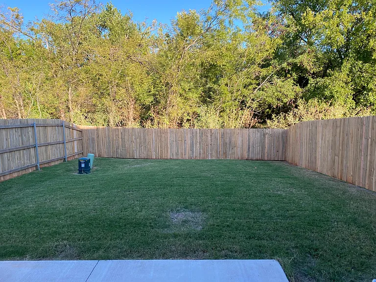 View from the back door of the fully fenced backyard that backs-up to a greenbelt....no neighbors and no street noise!
