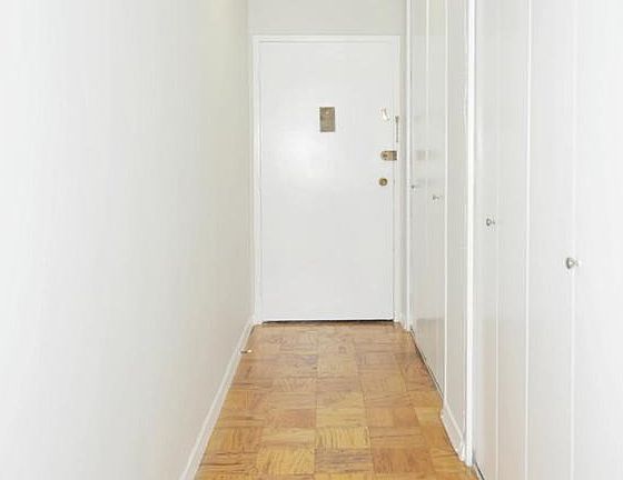 Long hallway with lots of closets