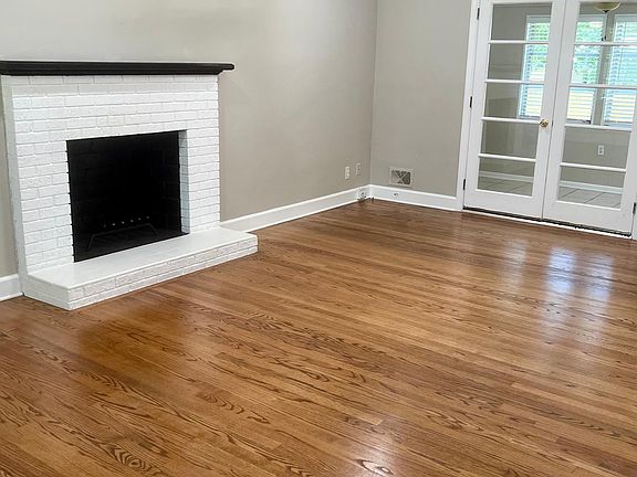 Living room with double doors into sunroom