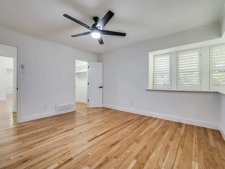 Secondary bedroom at front of home, with study at left rear of photo