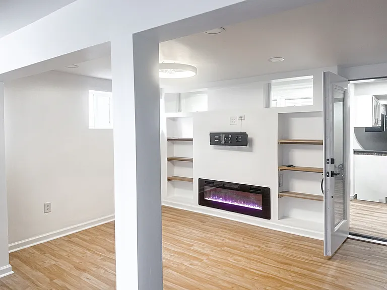 Enclosed three-season room featuring windows, ceiling light/fan, and a clean, comfortable layout.