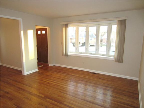 Gleaming hardwood floors and bay window in liv rm