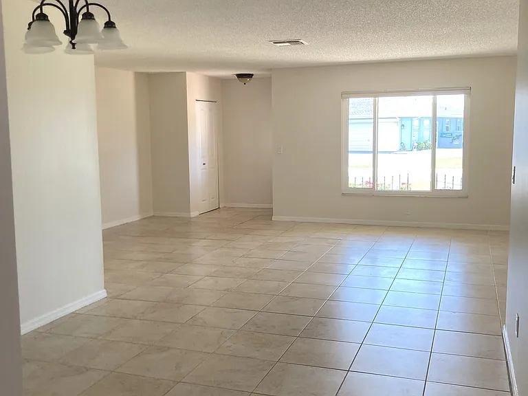 Looking towards the front door and front window. Livingroom and Dining room area