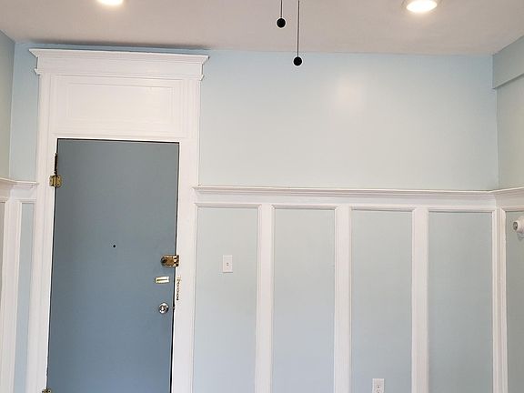 Front entry living room with crown molding, ceiling fan and recessed lights