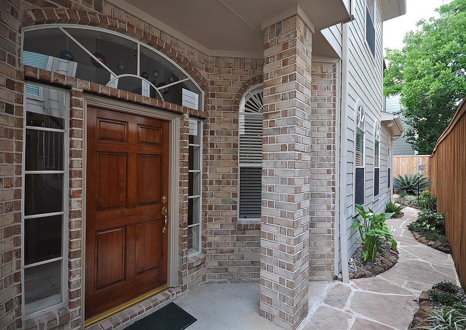 Updated brick home with stylish entry, first floor living, and plenty of light.