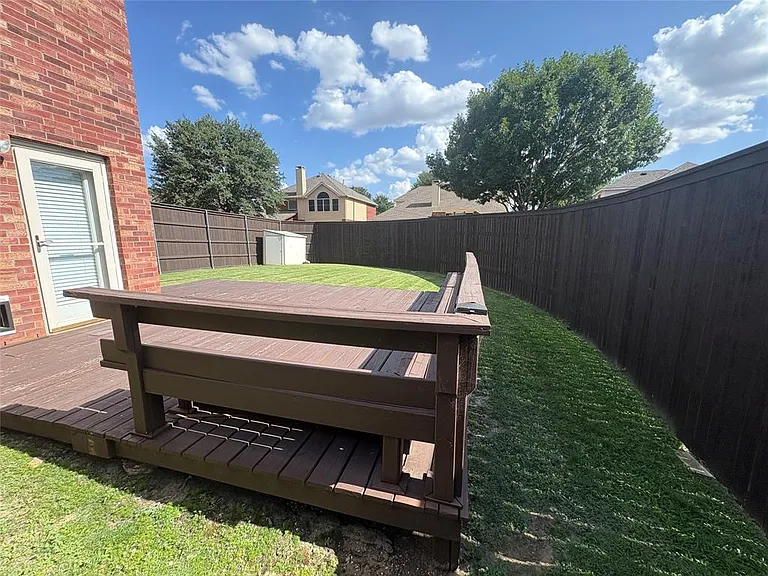 ANOTHER VIEW OF THE SECK WITH SEATING AND ROOMY YARD.