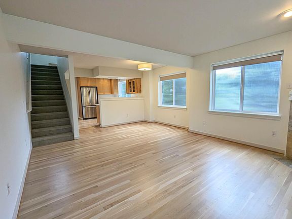 2nd floor - living area looking onto kitchen and stairway to 3rd floor