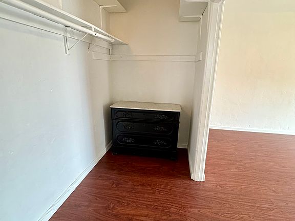 Large closet with a chest of drawers.