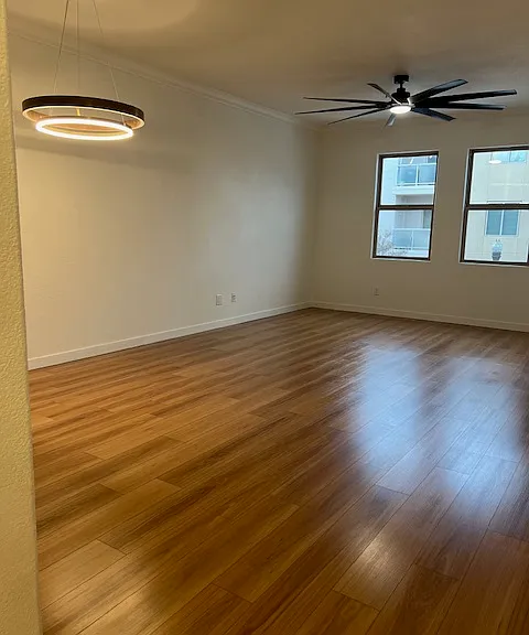 Living area with big ass fan and two large windows to lewis st. Dining area under the big decorative light