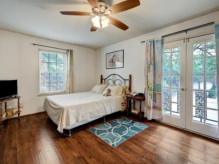Spacious primary bedroom with balcony.
