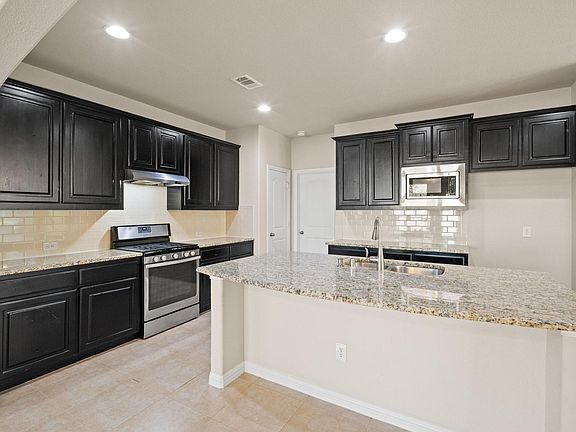 Kitchen has an abundance of cabinets and ss appliances.